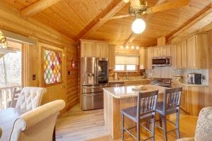 a kitchen with wooden walls and a wooden ceiling at Family-Friendly Riverfront Manor on the Little Red in Heber Springs