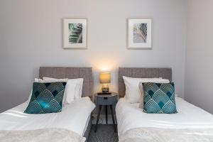 two beds sitting next to each other in a room at Beachfront Apartment 3 Bedrooms Sleeps 7 - Newly Refurbished in Morecambe