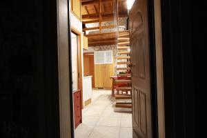 a hallway with a kitchen and a dining room at Il Cottage di Stella incantevole appartamento in SantʼOreste
