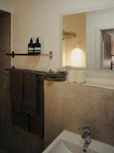 a bathroom with a sink and a mirror at Deluxe-Apartment Altstadt in Ettlingen