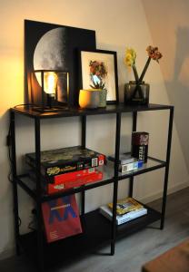 a black book shelf with books and a lamp at Deluxe-Apartment Altstadt in Ettlingen +31 photos