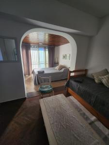 a bedroom with two beds and a room with a window at Costa de Tigre, habitaciones in Tigre