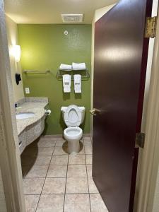 a bathroom with a toilet and a sink at Sleep Inn & Suites at Six Flags in San Antonio