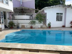 a swimming pool in front of a house at CASA : SIGNORELLI in Tarapoto