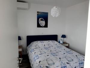 a bedroom with a bed and a picture on the wall at View of the Pelješki bridge in Drače