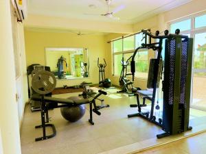 a fitness room with a gym with tread machines at AMERICAN ROYAL LODGE in Tamale