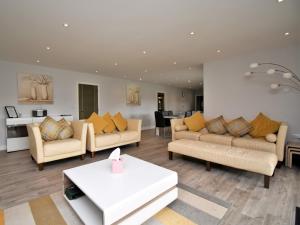 a living room with couches and a table at 4 Bed in Oswestry 75175 in Kinnerley