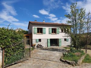 a house with a gate in front of it at Maison tranquille au Vans in Les Vans