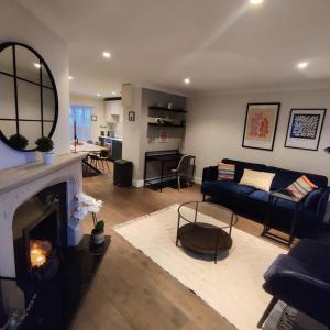 a living room with a couch and a fireplace at Faithlegg Mews in Waterford