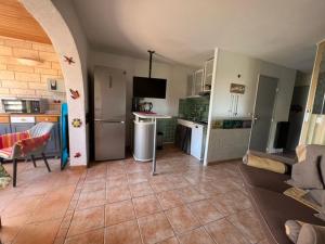a room with a kitchen and a living room at T2 rez de jardin plage piscines vue mer parking terrasse commerces in Six-Fours-les-Plages