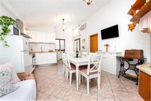 a kitchen and dining room with a table and chairs at Charming House Nino with a fenced yard in Krmed