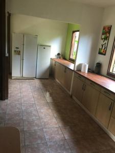 a kitchen with two white refrigerators and wooden cabinets at Maison Nature in Le Moule +10 photos
