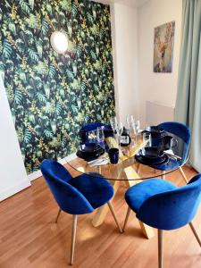 a dining room with a table with blue chairs at Stylish 2 bed & 2 bath City Centre Apartment with FREE PARKING in Sheffield
