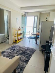 a living room with a couch and a table at Flat na praia in Vila Velha