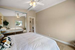 a bedroom with a large bed and a mirror at American Riviera Oasis Close to Beach and Downtown in Santa Barbara