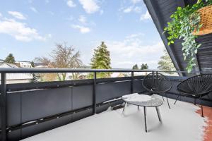 a balcony with two chairs and a table at Wohnung Weitblick in Neu-Anspach