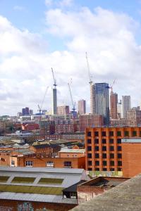a view of a city with cranes at Modern Luxurious Apartment in Birmingham