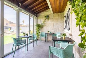a patio with tables and chairs and windows at CASA LALI in Las Lagunas