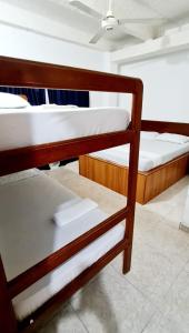 a group of bunk beds in a room at Hotel El Imperio in Santa Marta