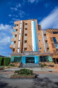 a large brick building with the front of it at Atlantic Garden Hotel in Barranquilla