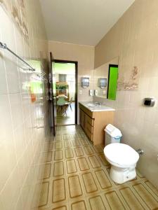 a bathroom with a toilet and a sink at Jardim Botânico House in Curitiba +72 photos