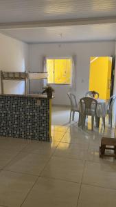 a kitchen and dining room with a table and chairs at Kitnet funcional in Angra dos Reis