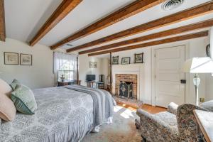 a bedroom with a bed and a fireplace at Terre Haute Manor Farmhouse with Gardens and Deck! in Midlothian