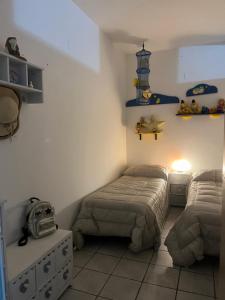 a bedroom with two beds and a lighthouse on the wall at Villa Melania in Rossano