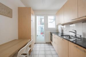 a kitchen with a sink and a counter top at Downtown Dream 3,5BR with Balcony and Style BA42 in Zurich