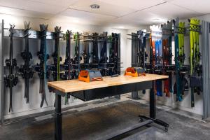 a room with a bunch of skis on the wall at Gravity Haus Steamboat in Steamboat Springs