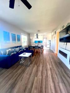 a living room with a blue couch and a table at Casita California - Private house with backyard in San Diego