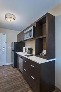 a kitchen with a sink and a microwave at TownePlace Suites by Marriott Columbia in Columbia