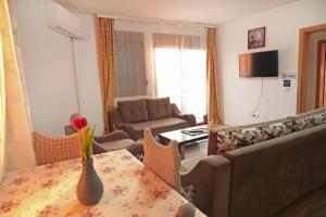 a living room with a couch and a table at Prizren Apartment's in Prizren