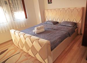 a bed with two towels on it in a bedroom at Prizren Apartment's in Prizren