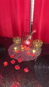 a table with flowers and candles on the floor at 12 Phantasm in Cap d'Agde