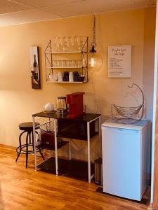 a room with a table and a small refrigerator at Escarpment Dwelling! in Hamilton