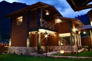 a house lit up at night with lights at Hot tub cabin at Sacred Valley in Calca