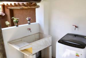 a bathroom with a sink and a washing machine at Hot tub cabin at Sacred Valley in Calca