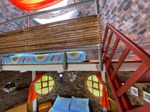 a room with a loft with a bed and a staircase at El Domo Macanal in Macanal
