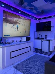a kitchen with a large screen in a room at 240 Magnifique Appart Deluxe Hammam vue mer in Cap d'Agde +39 photos
