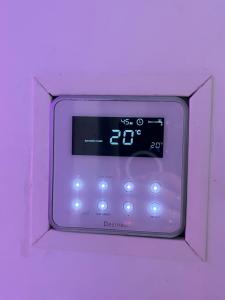 an alarm clock in a pink box with the time at 240 Magnifique Appart Deluxe vue mer in Cap d'Agde