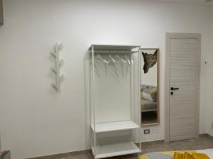 a white cabinet with a cat sitting on top of it at I Parienti Ra Zita in Ragusa