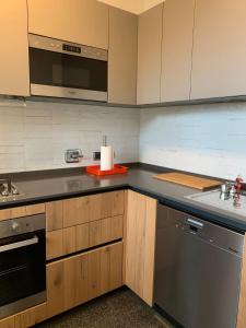 a kitchen with a stove and a sink and a microwave at Casa Paslawski in Corciano