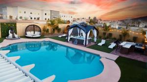 a swimming pool with a gazebo and a building at Buddha Mansion Luxury Resort - 8BR Modern, HotTub, Huge pool, Sauna, BBQ grill, Game Room in Las Vegas