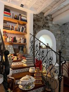 a room with a book shelf with books at 2 bedrooms house with wifi at Caccamo in Caccamo