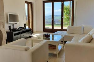 un soggiorno con divano e tavolo di 5 bedrooms house with private pool terrace and wifi at Ripatransone a Cossignano