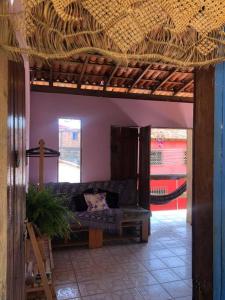 a living room with a couch under a roof at Studio com varanda in Itacaré