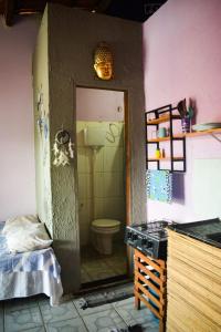 a bathroom with a sink and a toilet in a room at Studio com varanda in Itacaré