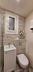 een witte badkamer met een toilet en een wastafel bij Joli studio bien équipé état neuf proche plage gare stationnement gratuit in Menton
