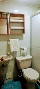 a bathroom with a toilet and a sink at Hospedaje Room's El Dorado in Bogotá